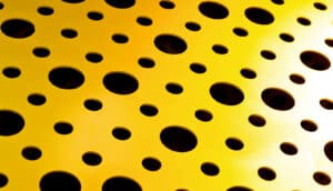 A yellow surface with many holes in it.