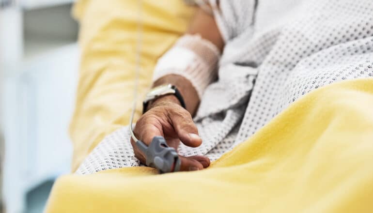 A person laying in a hospital bed.