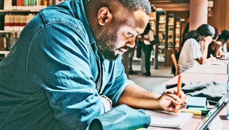 A man studies in a library.