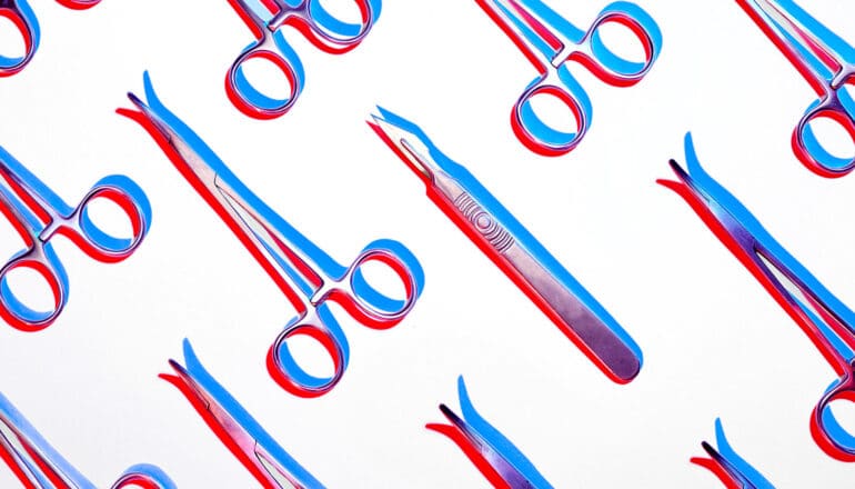 Scalpels and forceps arranged in rows on a white background.