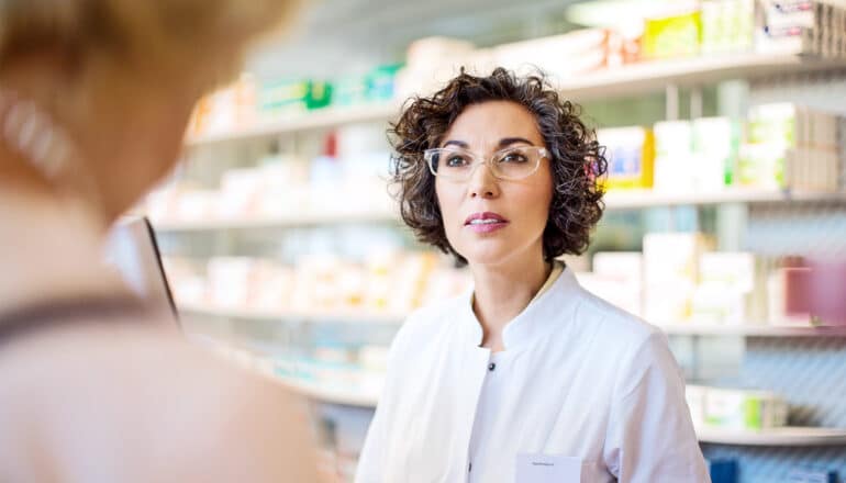 A pharmacist helps a customer.