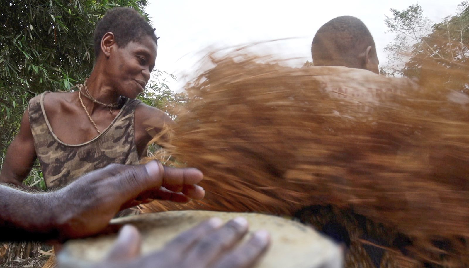 BaYaka hunter-gatherers in Congo playing musical instruments and dancing, which helps them to spread cultural traits and specialized vocabulary between different groups