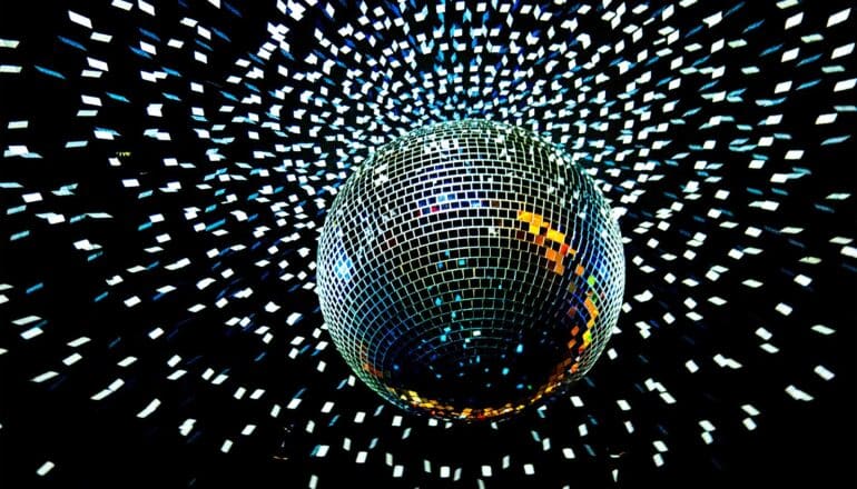 A discoball scatters light in a dark room.