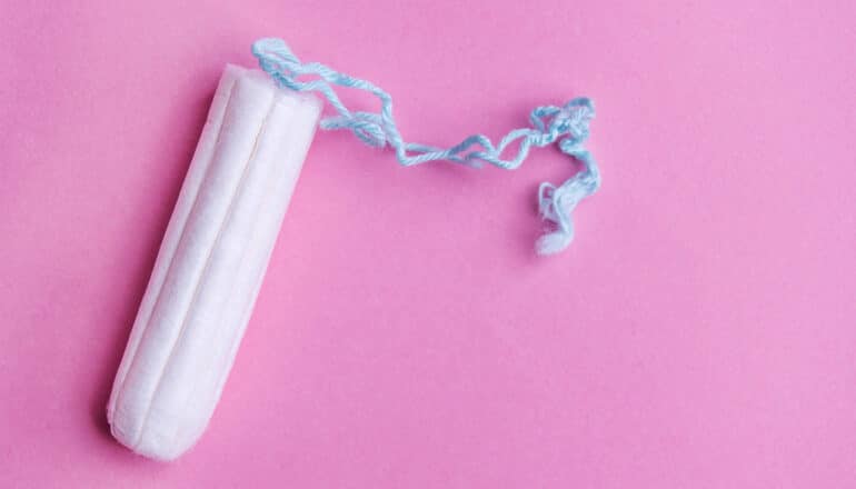 A tampon on a pink background.