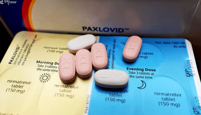 Paxlovid pills sit on a blister packs that hold more medication.