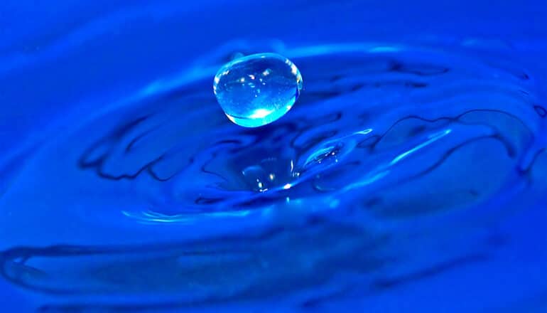 A drop of water splashes into more water.