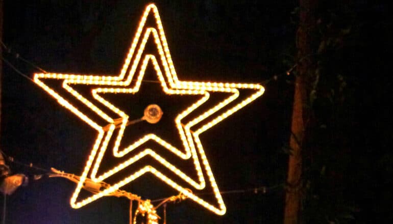 White lights arranged in the shape of a star against a dark background.