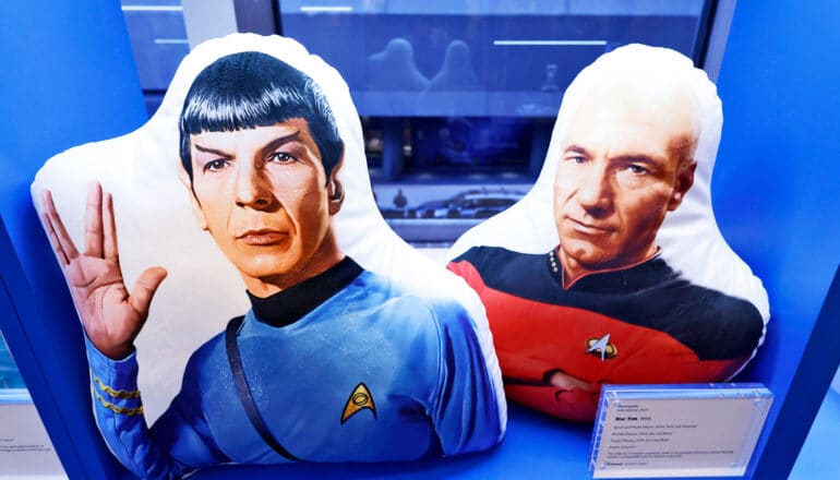 An image of Captain Picard and Spock from Star Trek shown at a convention inside glass.